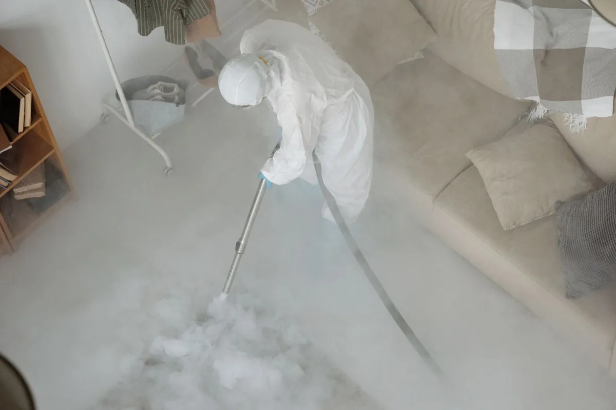 Biohazard cleanup technician in protective equipment, Northwest Ithaca, NY